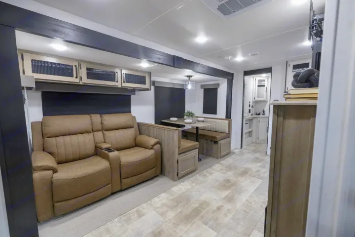 This RV rental boasts a bright, modern interior with a reclining sofa, dining booth, and well-equipped kitchen.. Palomino Puma 337BH 2025