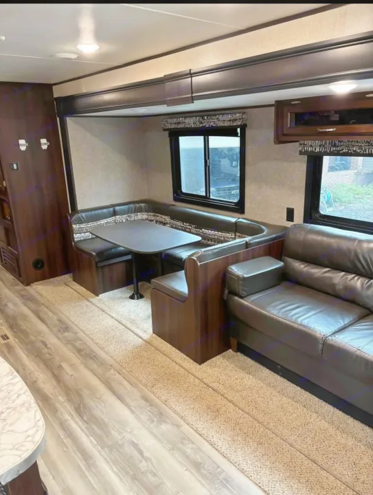 Enjoy this spacious RV rental interior: a comfy U-shaped dinette and plush sofa await.. Jayco Jay Flight SLX 2018