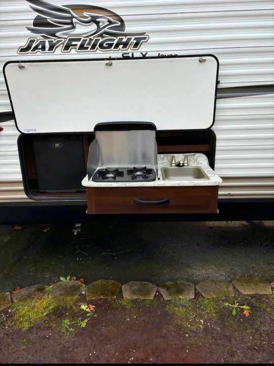 This Jay Flight RV rental features an outdoor kitchen with fridge, stove, & sink. Enjoy convenient camping meals!. Jayco Jay Flight SLX 2018