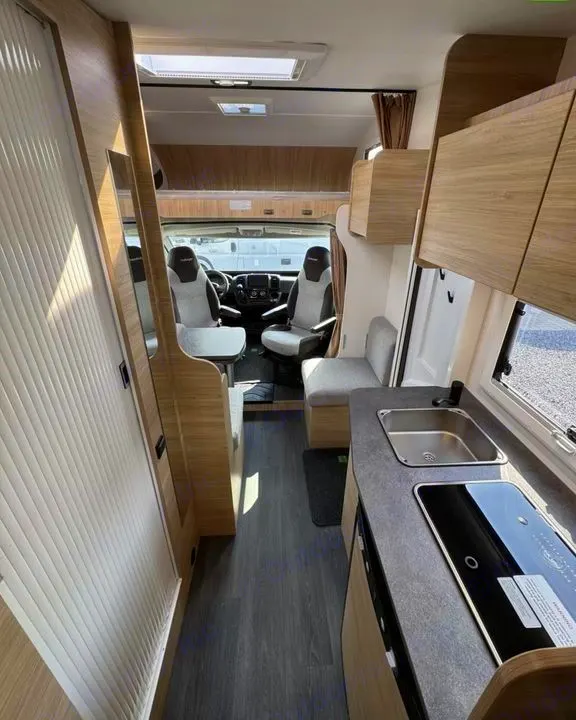 Spacious rv rental interior showing a modern kitchen, dining area, and driver's cabin. Ready for your next adventure.. Challenger C194 START EDITION 2025