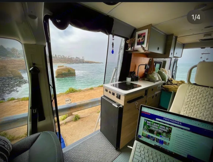RV rental van's interior: kitchen, laptop workspace with a stunning ocean view from a cliff. A perfect mobile office.. Dodge Winnebago 2021