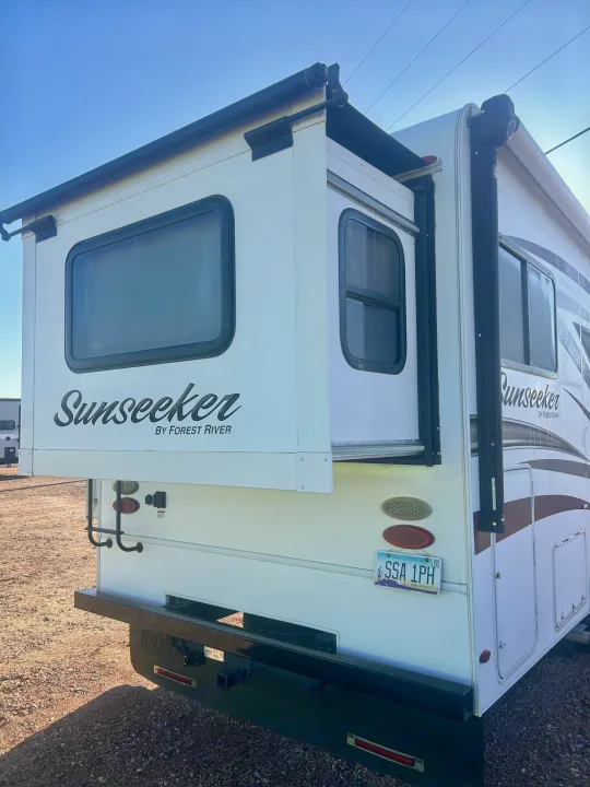 RV rental: A white Forest River Sunseeker RV with its slide-out extended, parked on gravel. Arizona license plate SSA 1PH.. Forest River Sunseeker 2017