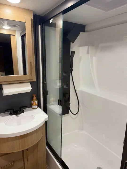 This RV rental offers a compact, modern bathroom with a full multi-jet shower system and vanity.. Heartland Cyclone 2025