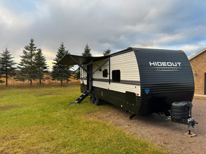 Spacious Hideout travel trailer with extended awning & steps, perfect for your next RV rental camping trip.. Keystone RV Hideout 2024