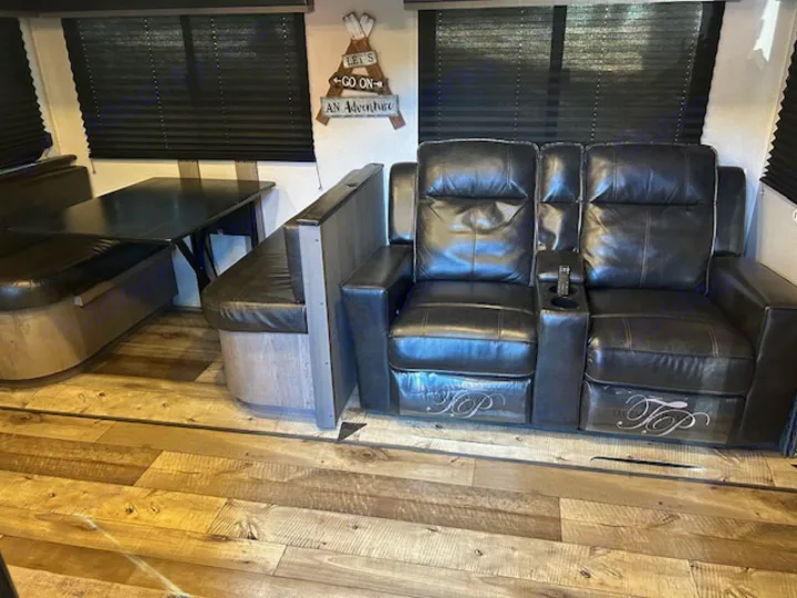 Cozy RV rental: Dinette booth and comfy theater seating recliners, ready for your adventure.. Keystone RV Outback Ultra-Lite 2021