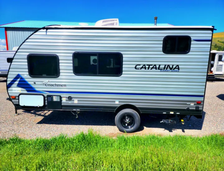 Coachmen Catalina Summit Series travel trailer for your next RV rental adventure, parked outdoors on a sunny day.. Coachmen 164BHX 2023