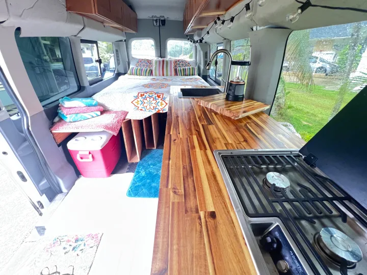 This rv rental features a well-appointed interior with a comfy bed, kitchen with stove and sink, and smart storage.. Ford Transit Custom 2016