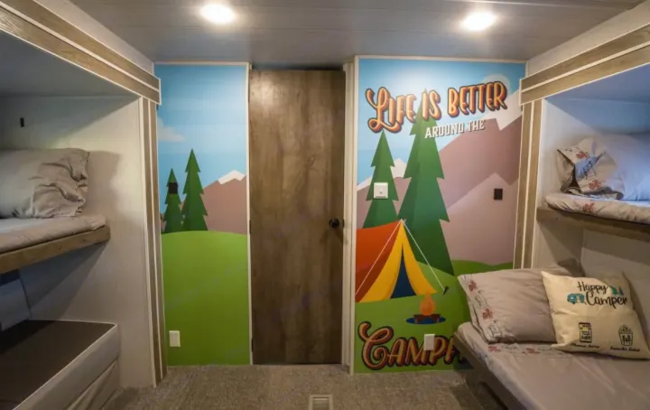 Cozy RV rental interior with bunk beds and a colorful camping mural, perfect for family adventures.. Forest River Salem 2022
