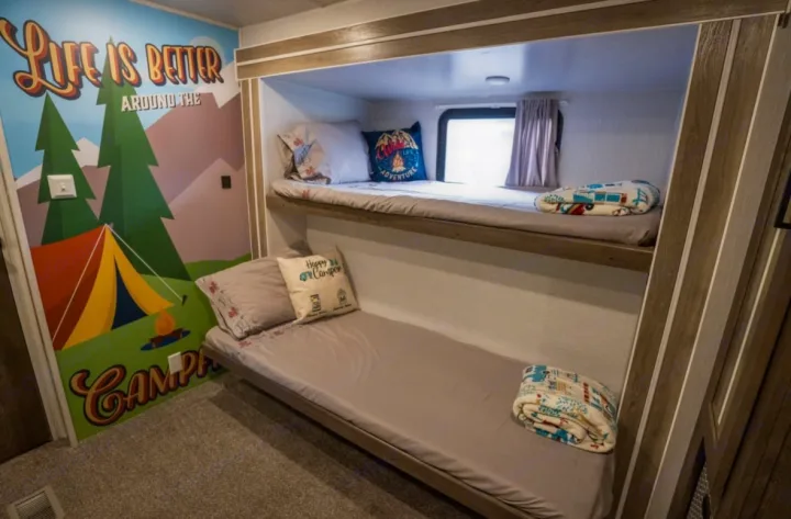 Cozy RV rental bunk beds with camping mural, perfect for family adventures.. Forest River Salem 2022