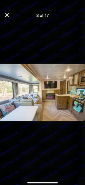 Spacious RV rental interior: large windows, comfy U-shaped dinette, modern kitchen, and fireplace for a cozy experience.. Forest River Salem 2022