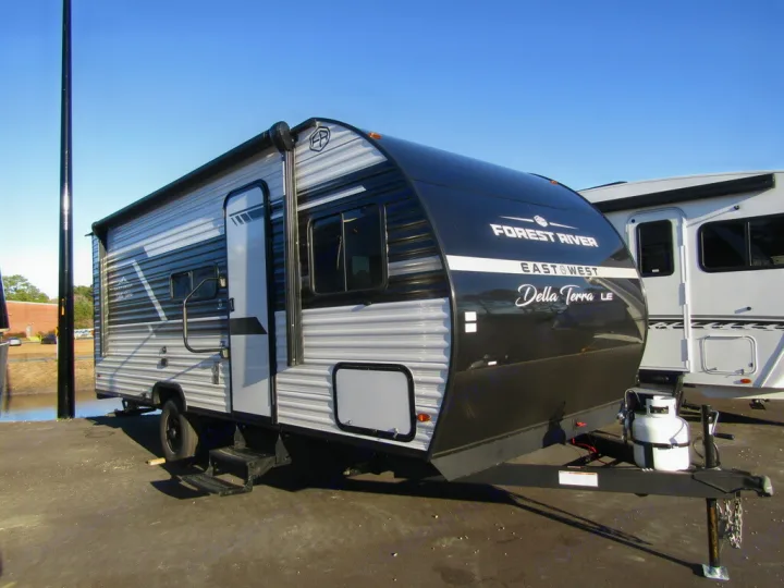 A new black and gray Forest River Della Terra LE travel trailer, ideal for an RV rental adventure.. East to West Della Terra 181BH 2025