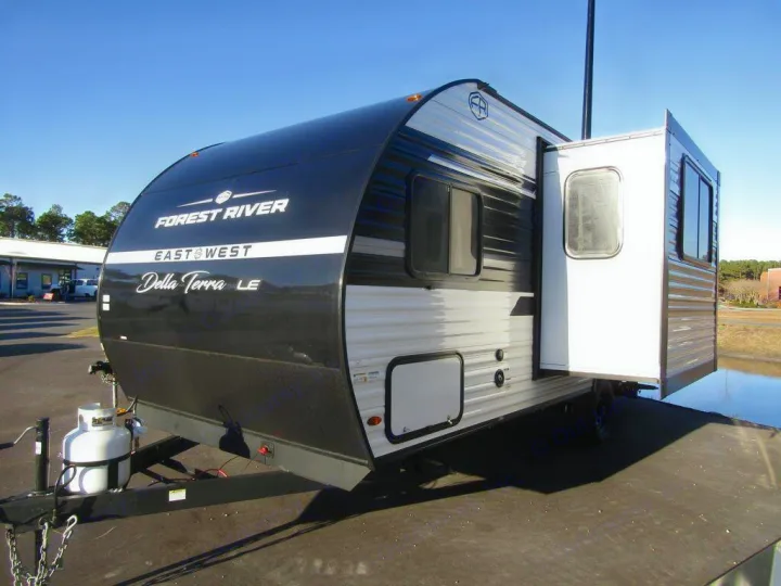 Black and white Forest River Della Terra LE travel trailer RV with an open slide-out, ideal for your rv rental trips.. East to West Della Terra 181BH 2025
