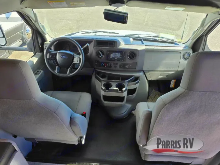 Experience comfort in this RV rental's front cabin. View of the driver's area, passenger seat, and full dashboard.. Freelander 21QSS 2025