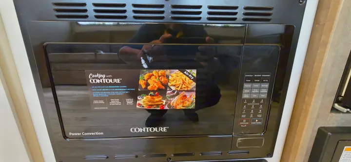 CONTOURE microwave convection oven with Air-Fry functions, ideal for versatile cooking in an RV rental kitchen.. Keystone Springdale 2025