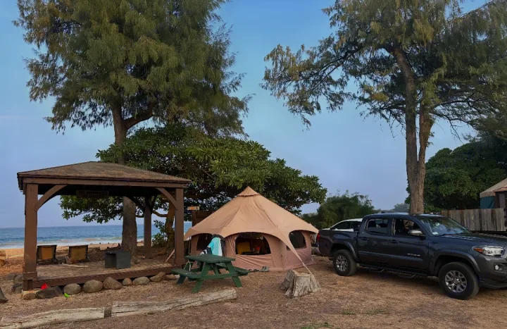 Beachside glamping tent and pickup truck by the ocean, offering a unique outdoor stay—a great alternative to an RV rental.. Ford Ford transit 2024