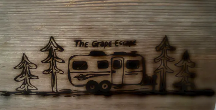 Wood-burned art: "The Grape Escape" RV rental ad. Features an RV & pine trees, perfect for camping.. Escape Trailer Escape Trailer Trailer 2022