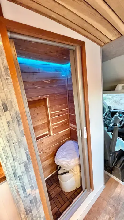 Compact RV rental wet bath with portable toilet, wood accents, and blue LED light. Ideal for travel!. Ford Transit 2019