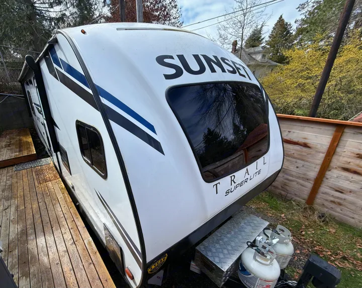 White Sunset Trail Super Lite travel trailer, with front and side visible, excellent for rv rental.. Crossroads Sunset Trail Super Lite 2021
