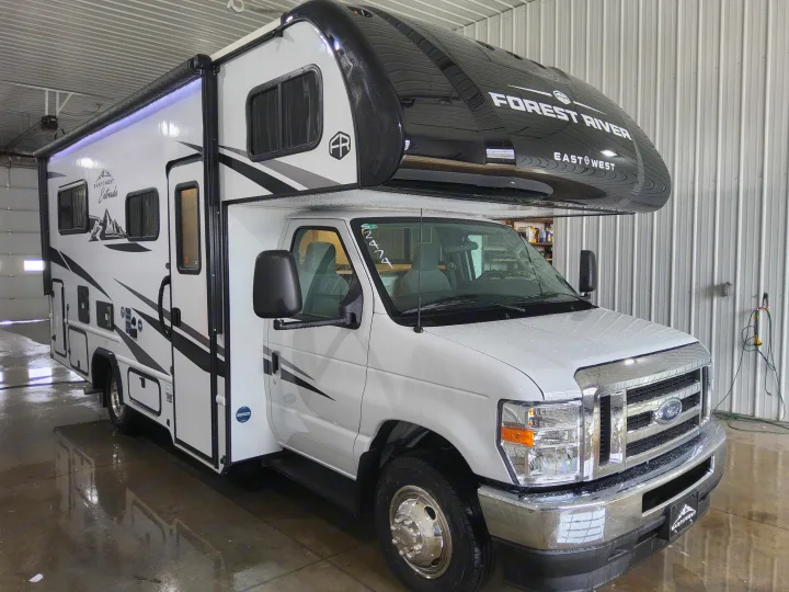 East to West Entrada Class C RV, a potential rv rental, gleaming clean in a service bay.. East To West Entrada 2000NS 2025