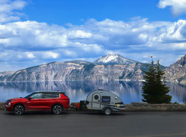 Crater Lake vista: Red SUV towing a teardrop camper (ideal RV rental for mountain views & lake reflections).. T@G XL 2016