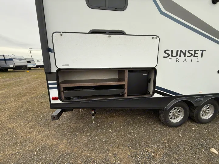 RV rental travel trailer with an open outdoor kitchen, featuring a mini-fridge and pull-out grill.. Crossroads Sunset Trail Super Lite 2019