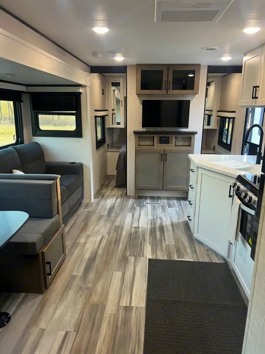 Spacious RV rental interior featuring a modern living area, full kitchen, and a glimpse of the bedroom.. Jayco Jayflight 324bds 2025