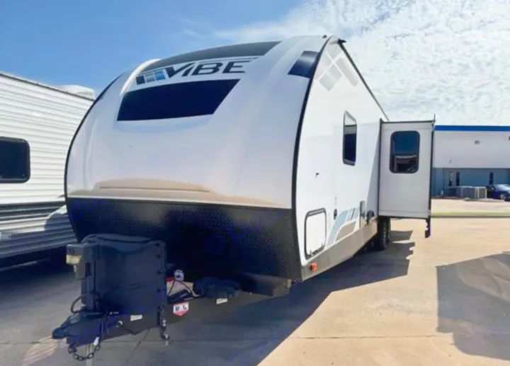 Modern white Vibe travel trailer, ideal for RV rental, parked outdoors on a sunny day.. Forest River Vibe 2022