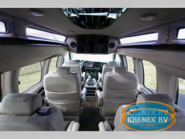 Spacious luxury RV rental interior with multiple rows of comfortable seating, ideal for group travel.. Chevrolet Explorer Luxury Van 9 Passenger 2023