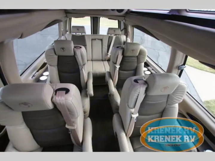 Spacious luxury RV interior with comfortable captain's chairs. Ideal for your RV rental.. Chevrolet Explorer Luxury Van 9 Passenger 2023