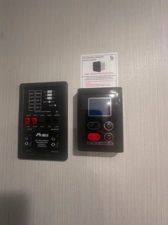 PUMA control panel & Girard tankless water heater controls in an RV rental. Monitor tank levels, lights, slide, and water temp.. PALOMINO 28BHSS 2024
