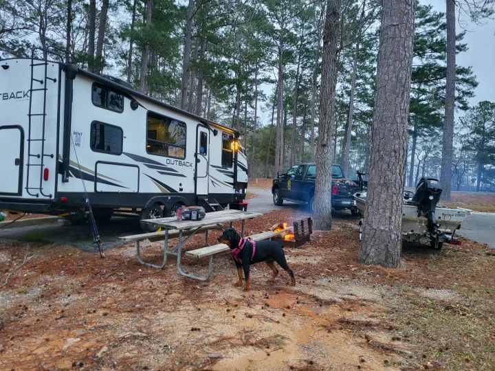 RV rental at a wooded campsite with a dog, campfire, truck, and boat for fishing. Perfect outdoor escape!. Keystone Outback 2021