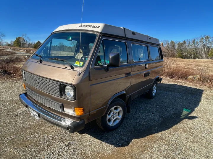 Brown Volkswagen Westfalia pop-top camper van, an iconic choice for an RV rental.. Volkswagen Westfalia 1985