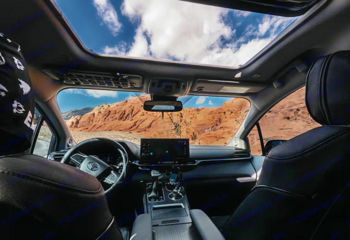 RV rental interior, showcasing red rock mountains through windshield and sunroof. Ideal for an adventure road trip.. Toyota Other 2025