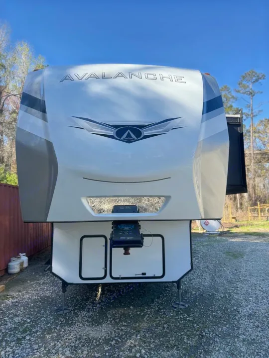 Experience comfort! This white Avalanche fifth-wheel RV, ready for rv rental, features a unique front design.. Keystone RV Avalanche 2022