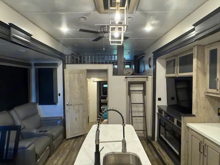 Step inside this spacious rv rental, showcasing a full kitchen, living area with recliners, and an accessible loft.. Keystone RV Avalanche 2022