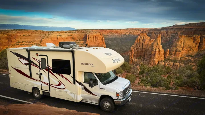 Jayco Redhawk RV rental overlooking a vast, rugged canyon landscape with dramatic rock formations.. Jayco Redhawk 2016