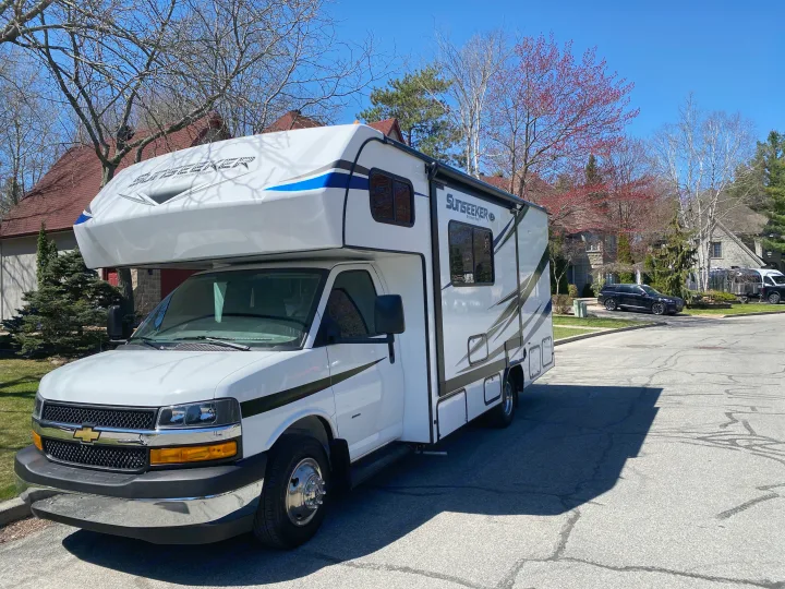 Shiny white Sunseeker Class C motorhome parked on a sunny day. Explore with this RV rental!. Forest River Sunseeker LE 2021