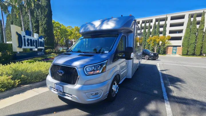 Silver Tiffin RV rental parked near the Disneyland Hotel sign, perfect for a family trip to Southern California.. Tiffin Motorhomes Allegro Midas 24MT 2024