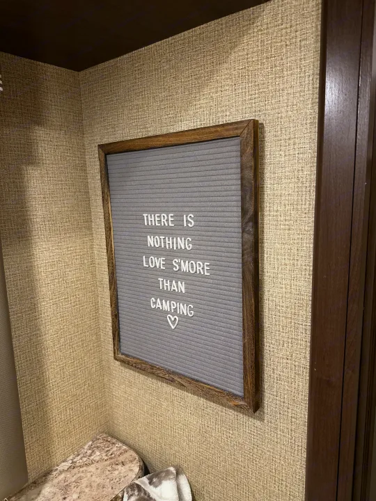 Cozy RV rental interior with a fun "Love S'more Than Camping" letter board, perfect for your next adventure.. Thor Four Winds 2018