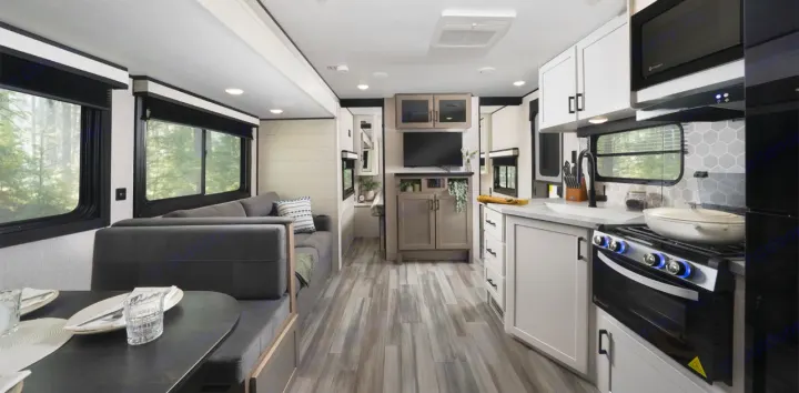 Spacious, modern RV rental interior featuring a full kitchen, living area with sofa, and dinette setup.. Jayco Jay Flight 261BHS 2025