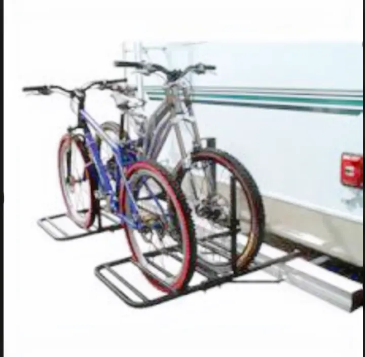 Two bicycles on a black metal rear RV bike rack, attached to a white RV, perfect for outdoor travel and RV rental adventures.. Coachmen Apex Nano 2023