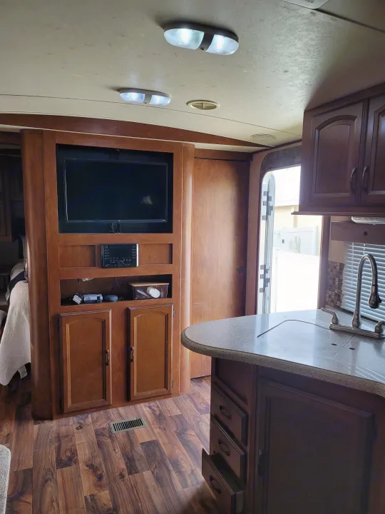Explore this inviting RV rental interior: a compact living space with entertainment, kitchen, and durable flooring.. Forest River Wildwood Heritage Glen Lite 2014