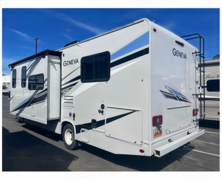 White Class C Geneva RV rental parked outside, featuring black and blue graphics, ready for your road trip adventure.. Thor Geneva 2022
