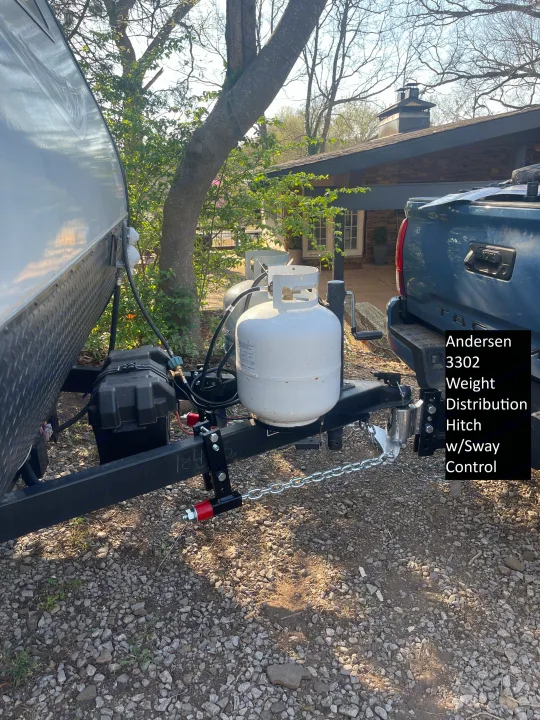 Andersen hitch connecting an RV rental trailer with propane tanks to a truck, ready for travel.. Jayco Jay Flight SLX 2021