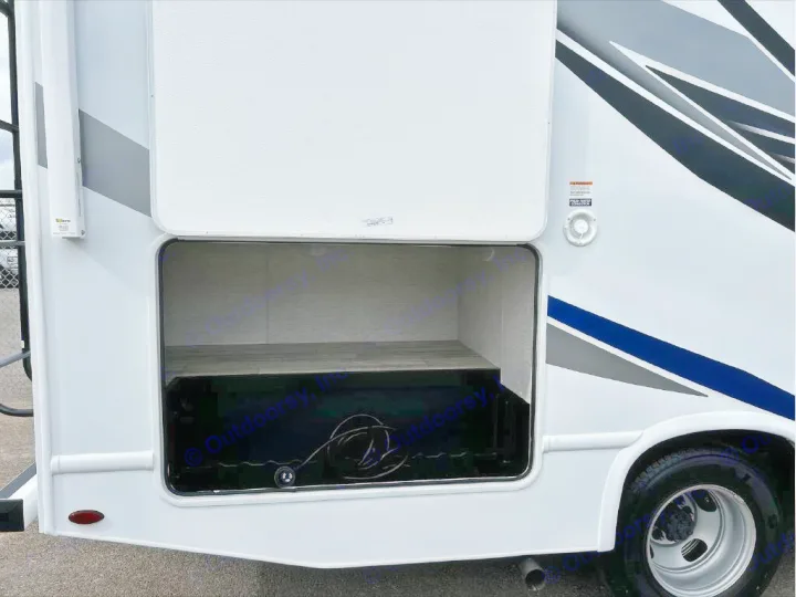 This RV rental's side view showcases a large, open exterior storage compartment, empty and ready for gear. White motorhome body.. GMC/THOR MAGNITUDE 2025