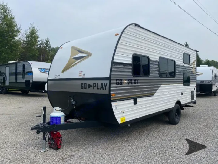 Explore with this Go Play travel trailer RV rental, gleaming white and gray, ready for adventure on a gravel lot.. Other Other 2025