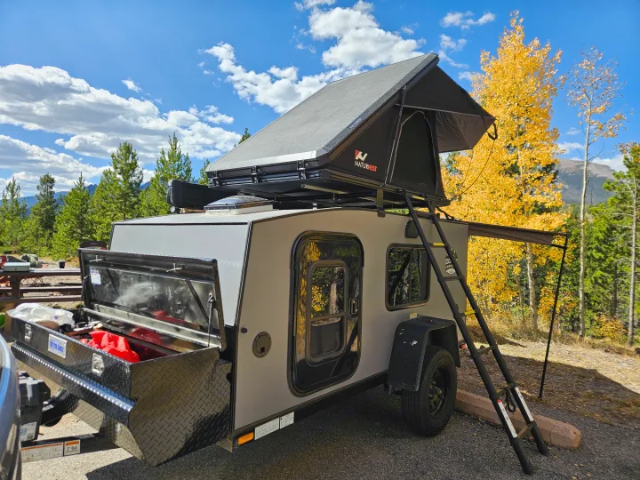 Teardrop camper trailer with a NaturNest rooftop tent, parked in a scenic fall mountain setting, great for an RV rental.. Escapade Ridge 2018