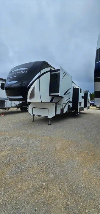 Modern black and white fifth-wheel RV on a gravel lot, perfect for your next rv rental adventure.. K-Z Manufacturing Durango 2021