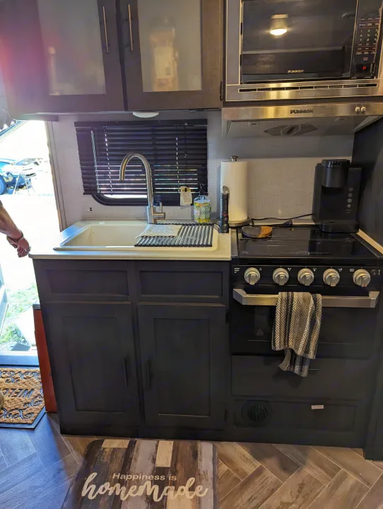 RV rental kitchen: modern design with Furrion stove, microwave, sink, and ample cabinets for your travels.. Forest River 2700TH 2021
