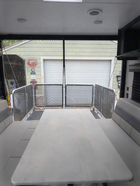 Inside this RV rental: Dinette with open rear ramp & protective screen. Experience mobile outdoor living.. Forest River 2700TH 2021